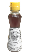 Back of bottle of Kadoya Pure Sesame Oil, 5.5 fl oz, imported from Japan for enhancing Asian dishes like ramen, BBQ, and poke bowls. 