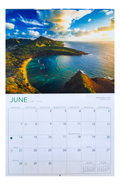 June 2026 calendar page with a scenic aerial view of Hanauma Bay, Oʻahu. The calendar features bilingual English and Hawaiian day names, moon phases, and holiday markings.