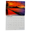 Calendar with a February 2027 layout featuring a sunset over a body of water and cityscape.