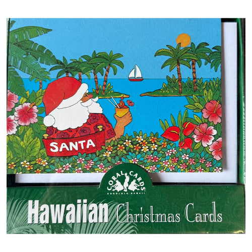 Santa in a chair looking at the tropical ocean