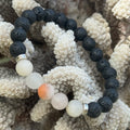Black and white beaded bracelets on a textured beige surface