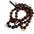 Black and brown beaded graduation lei with charms on a white background