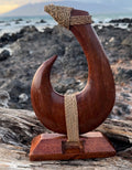 Carved wooden hook with a rope against a scenic background