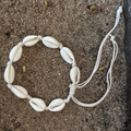 Bracelet made of shell beads on a sandy background