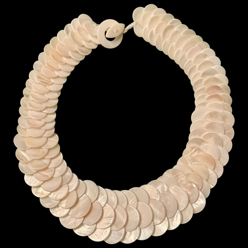 Necklace made of round, beige shell beads on a black background