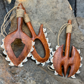 Wooden tools with shark teeth on a stone surface