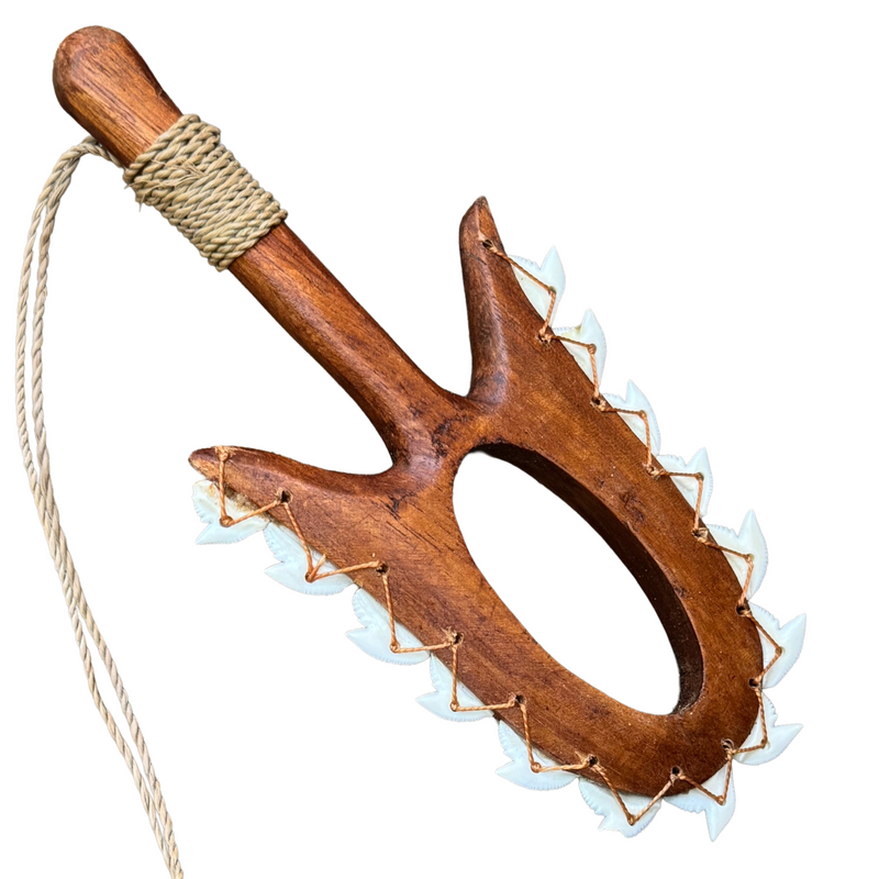 Wooden tool with a handle and spiky design on a white background