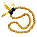 Yellow mongo shell necklace with a black kukui and yellow ribbon on a white background