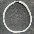 White shell necklace on a charcoal background