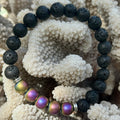 Black beaded bracelet with colorful beads on a coral background
