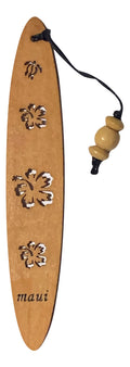 A collection of wooden bookmarks with Hawaiian inspired designs, featuring phrases and images related to Hawaii, displayed on a surface with a floral patterned book in the background.