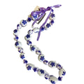 White Kukui Nut Lei with Purple Flower on a white background