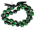 A black and green kukui nut lei with a turtle pattern and an adjustable black ribbon closure.