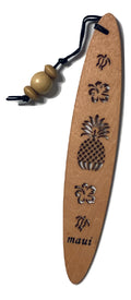 A collection of wooden bookmarks with Hawaiian inspired designs, featuring phrases and images related to Hawaii, displayed on a surface with a floral patterned book in the background.