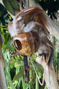 Handmade Ikaika Makakiʻi Hawaiian warrior helmet mask with brown feathers and beads, made from real coconut. side view