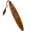 A collection of wooden bookmarks with Hawaiian inspired designs, featuring phrases and images related to Hawaii, displayed on a surface with a floral patterned book in the background.